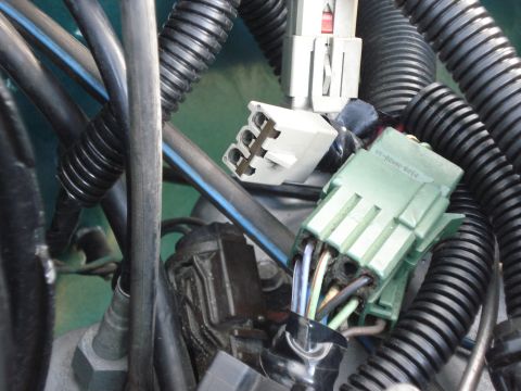 1979 Ford F-150 - Close-up of engine wiring harness connectors and protective tubing.