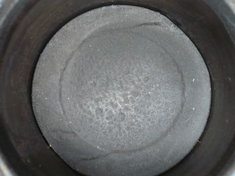 1975 Ford Ranchero - Close-up view of a piston top within an engine cylinder.