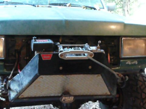 1990 Ford Bronco - Front bumper and winch assembly on an off-road vehicle.