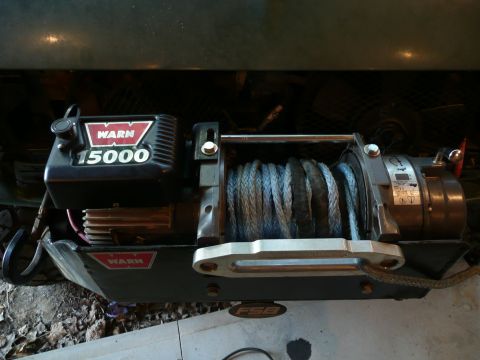 1990 Ford Bronco - Warn 15000 winch with rope, mounted on a vehicle's front end.