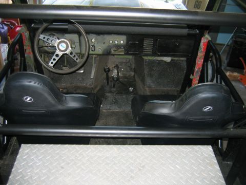 1992 Ford Mustang - The interior of a classic Ford Bronco, a roll cage and aftermarket seats.