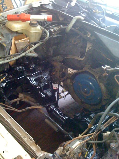 1996 Ford Crown Victoria - The engine bay shows a black painted engine block and a blue torque converter, with various hoses and wires visible.