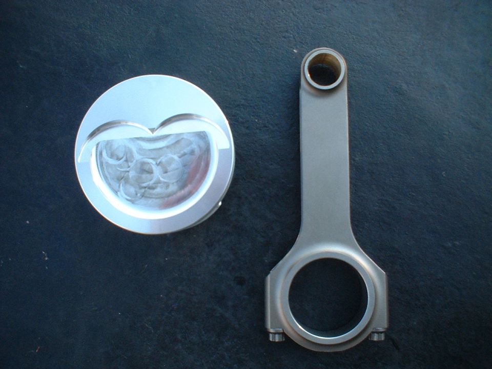 Piston with heart-shaped valve relief and connecting rod