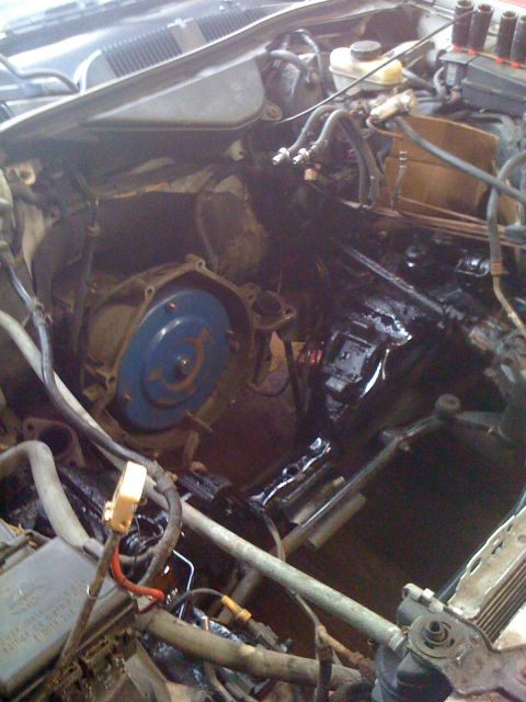 1996 Ford Crown Victoria - View of the engine bay with the transmission removed, revealing the torque converter and bell housing.