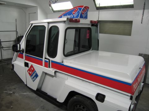 2001 Ford Crown Victoria - This custom Domino's Pizza delivery vehicle features the company's branding and a covered cargo area.
