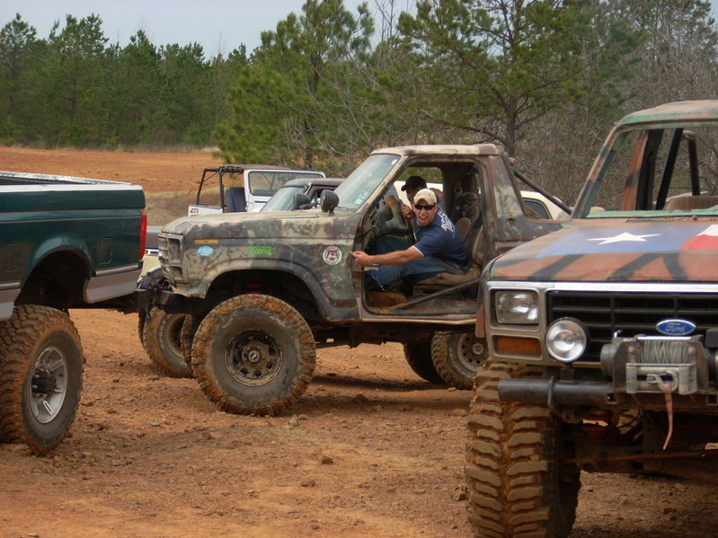 Camouflaged off-road SUV, 3/4 front view. The vehicle appears to be from the early 1980s