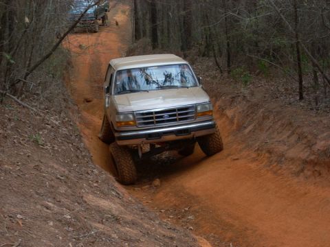 1996 Ford Bronco - Ford Bronco tackles a challenging off-road trail during a group run.