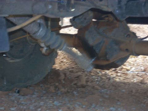 1996 Ford Bronco - Undercarriage view showing the rear axle assembly and suspension parts of a vehicle.