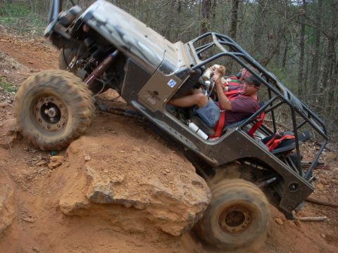 1996 Ford Bronco - Off-road vehicle navigating a steep, rocky trail during an event.