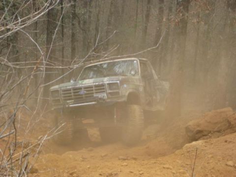 1996 Ford Bronco - This lifted Ford truck navigates a dusty off-road trail.