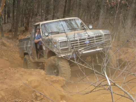 1996 Ford Bronco - A heavily modified Ford Bronco navigates a challenging off-road course.