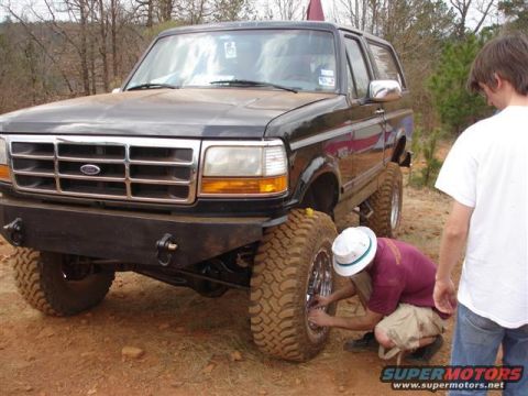 1996 Ford Bronco - Modified 1996 Ford Bronco with off-road tires and suspension, being serviced outdoors.