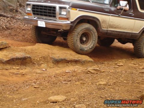 1996 Ford Bronco - This Ford Bronco is shown off-road, with its front end angled over rocks and dirt.
