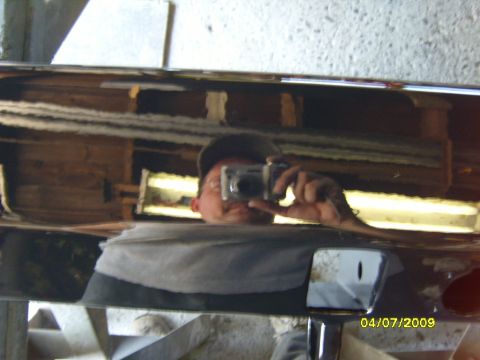 1989 Ford Bronco - Reflection of a person taking a photo of a chrome rear bumper, dated 04/07/2009.