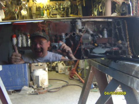 1989 Ford Bronco - Man gives a thumbs up while holding a spray can, reflected in a shiny surface in a garage.