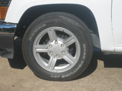 1996 Ford Thunderbird - Close-up of a white vehicle's front wheel and tire, Kumho Road Venture APT branding.