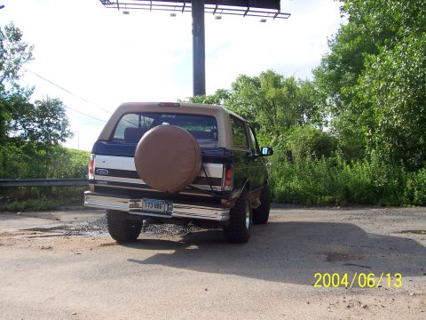 1990 Ford Bronco - This 1990 Ford Bronco is seen from the rear, a spare tire mounted on the tailgate and a two-tone paint scheme.