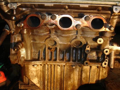 1990 Ford Taurus - Close-up of an engine block, showing internal components and signs of wear.