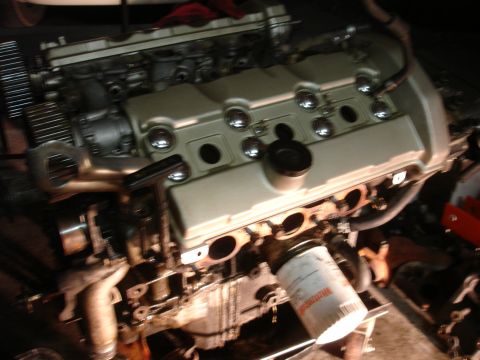 1990 Ford Taurus - A close-up view of a vehicle engine, with an oil filter prominently displayed.