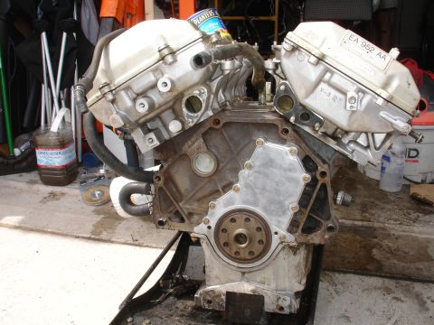 1990 Ford Taurus - Engine block assembly with valve covers and hoses, part number EA 952 AA visible.