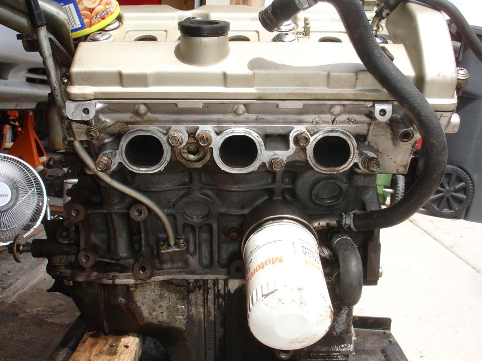Engine block with oil filter and exhaust manifold ports