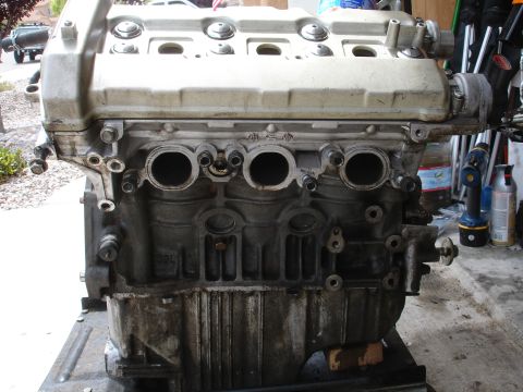 1990 Ford Taurus - This is a close-up view of a vehicle engine block, likely undergoing maintenance or repair.