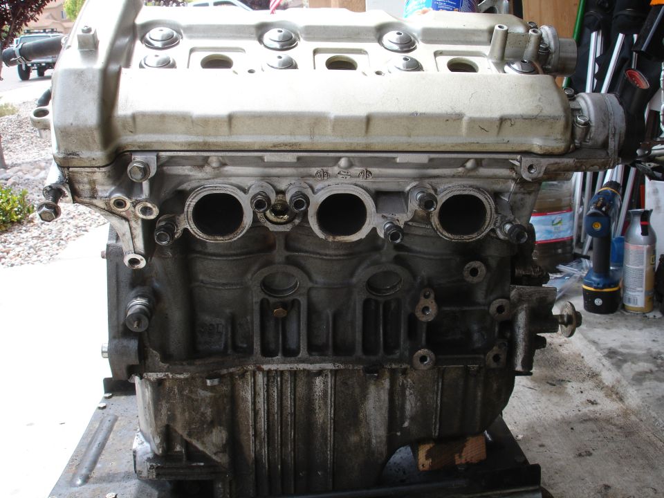 engine block with intake manifold removed, showing cylinder head and oil pan