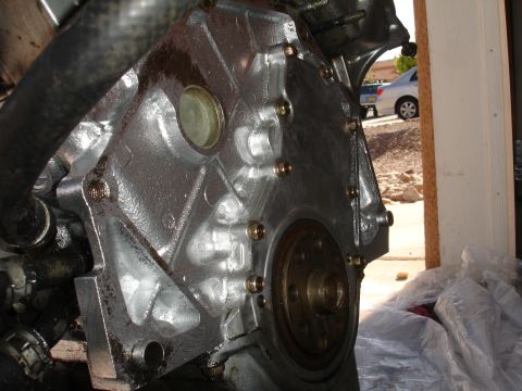 1990 Ford Taurus - A close-up view of a vehicle's engine block, showing mechanical components and bolts.