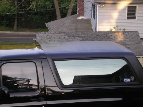 1995 Ford Bronco - Side view of a black SUV, showing the rear side window with an FSB sticker.