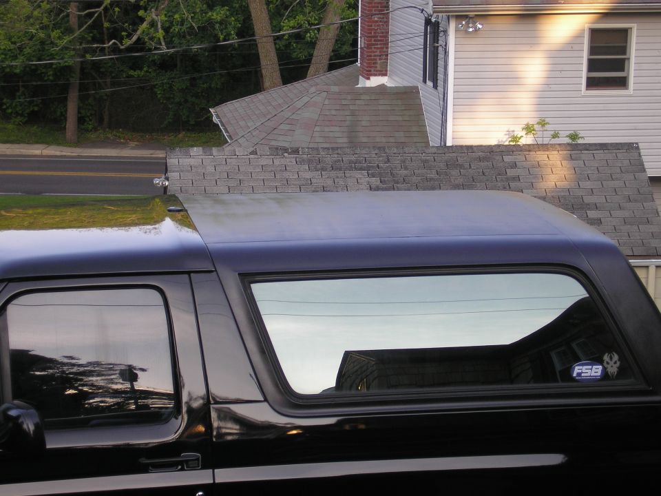 Side view of black SUV removable hardtop with tinted quarter window and blue FSB decal