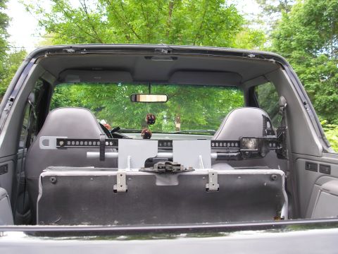 1995 Ford Bronco - The interior of a 1995 Ford Bronco shows a hi-lift jack mounted securely behind the front seats.