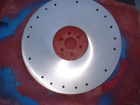1970 Ford Torino - A close-up view of a clutch assembly, likely for a manual transmission vehicle, is shown against a textured background.