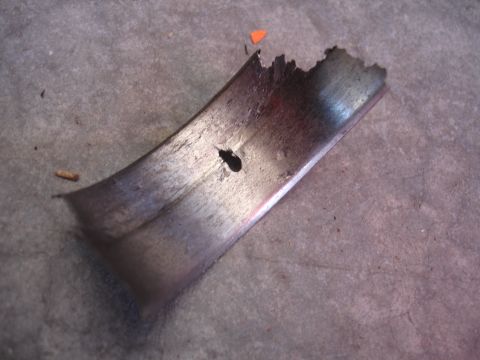 1992 Ford Taurus - This damaged engine bearing shows signs of severe wear and failure.
