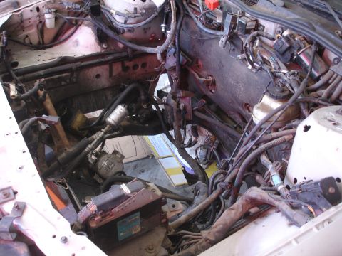1992 Ford Taurus - The engine bay of a car is shown with many components disassembled for maintenance or repair.