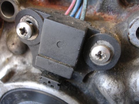 1992 Ford Taurus - Close-up view of an engine sensor with visible wiring, mounted to a metal engine block.