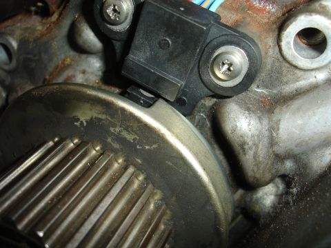 1992 Ford Taurus - A close-up view of an engine component, likely a crankshaft position sensor and reluctor wheel.