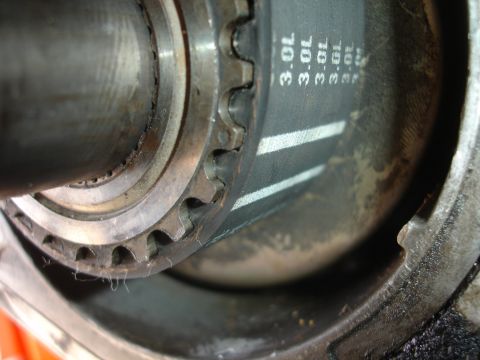1992 Ford Taurus - A timing belt with '3.0L' text and a toothed pulley are visible in this close-up engine part photo.