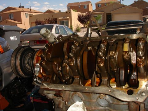 1992 Ford Taurus - Close-up of an engine block with a 1992 Ford Taurus visible in the background.