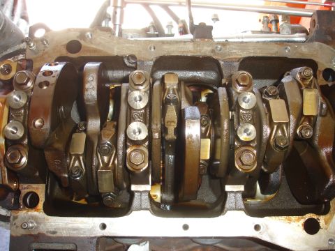 1992 Ford Taurus - Close-up view of an engine's crankshaft and connecting rods, showing internal components and some part numbers.