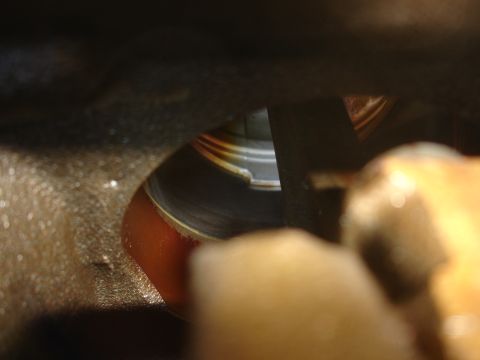 1992 Ford Taurus - A detailed look into an engine cylinder, revealing the piston's surface and signs of lubrication.