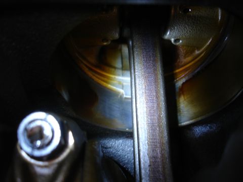 1992 Ford Taurus - Engine crankshaft bearing showing wear and oil residue.