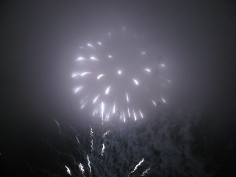1985 Ford LTD Crown Victoria - A bright fireworks display illuminates the foggy night sky with streaks of light.