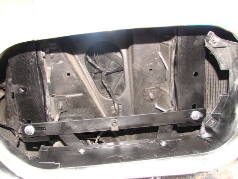 1973 Ford Ranchero - The internal structure of a vehicle's front end is visible, including the radiator and wiring harness.