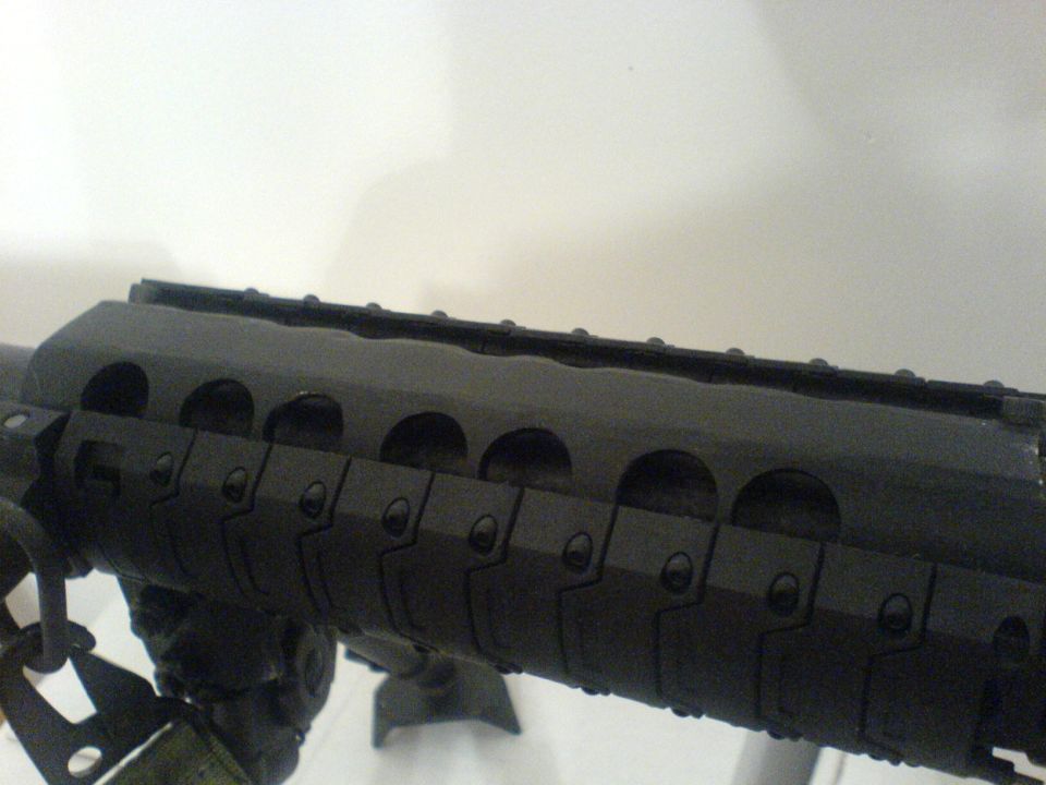 Black rifle handguard with Picatinny rails and ventilation slots