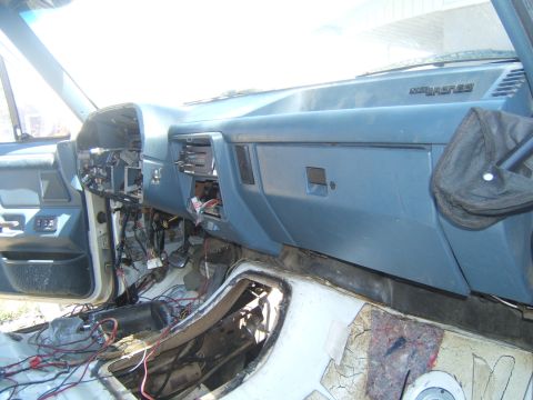 1988 Ford Bronco - The interior of a disassembled vehicle shows exposed wiring and a blue dashboard with "BRONCO" text.