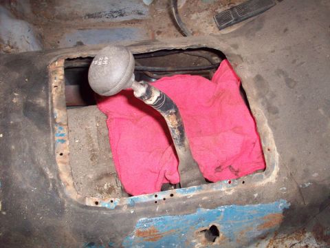 1978 Jeep CJ5 - The 1978 Jeep CJ5's interior reveals its 4WD shifter, marked with gear options, partially obscured by a pink cloth.
