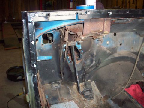 1978 Jeep CJ5 - The interior firewall of a 1978 Jeep CJ5 shows blue paint, rust, and the brake pedal assembly.
