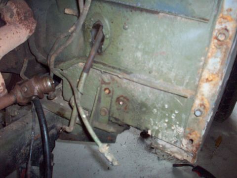1978 Jeep CJ5 - Close-up view of engine bay components, including steering linkage and exhaust pipe, on a vintage vehicle.