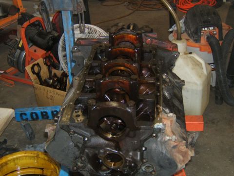 1988 Ford Bronco - Engine block and crankshaft assembly, likely undergoing rebuild or repair in a garage.