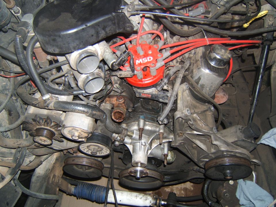 Engine bay with MSD distributor, dual throttle bodies, and water pump
